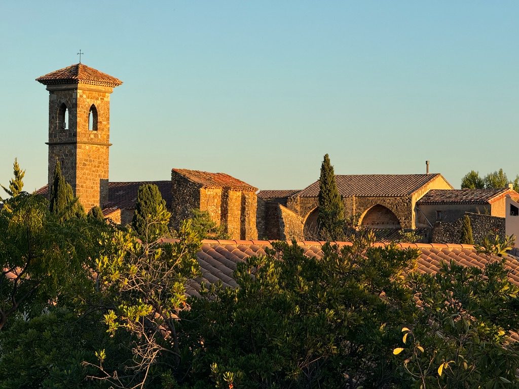 A village church and tiled roofs in the last light, Languedoc