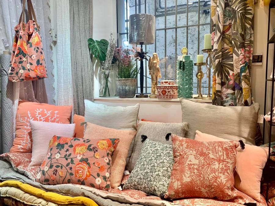 Printed cushions and cloth stacked in a textile shop